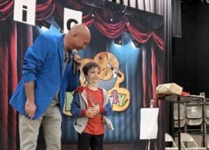 A man and boy in front of a stage.