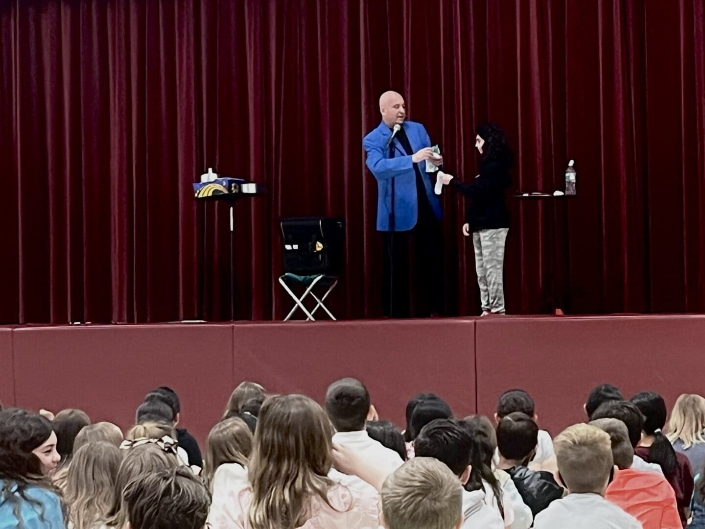 A man and woman on stage with a microphone.