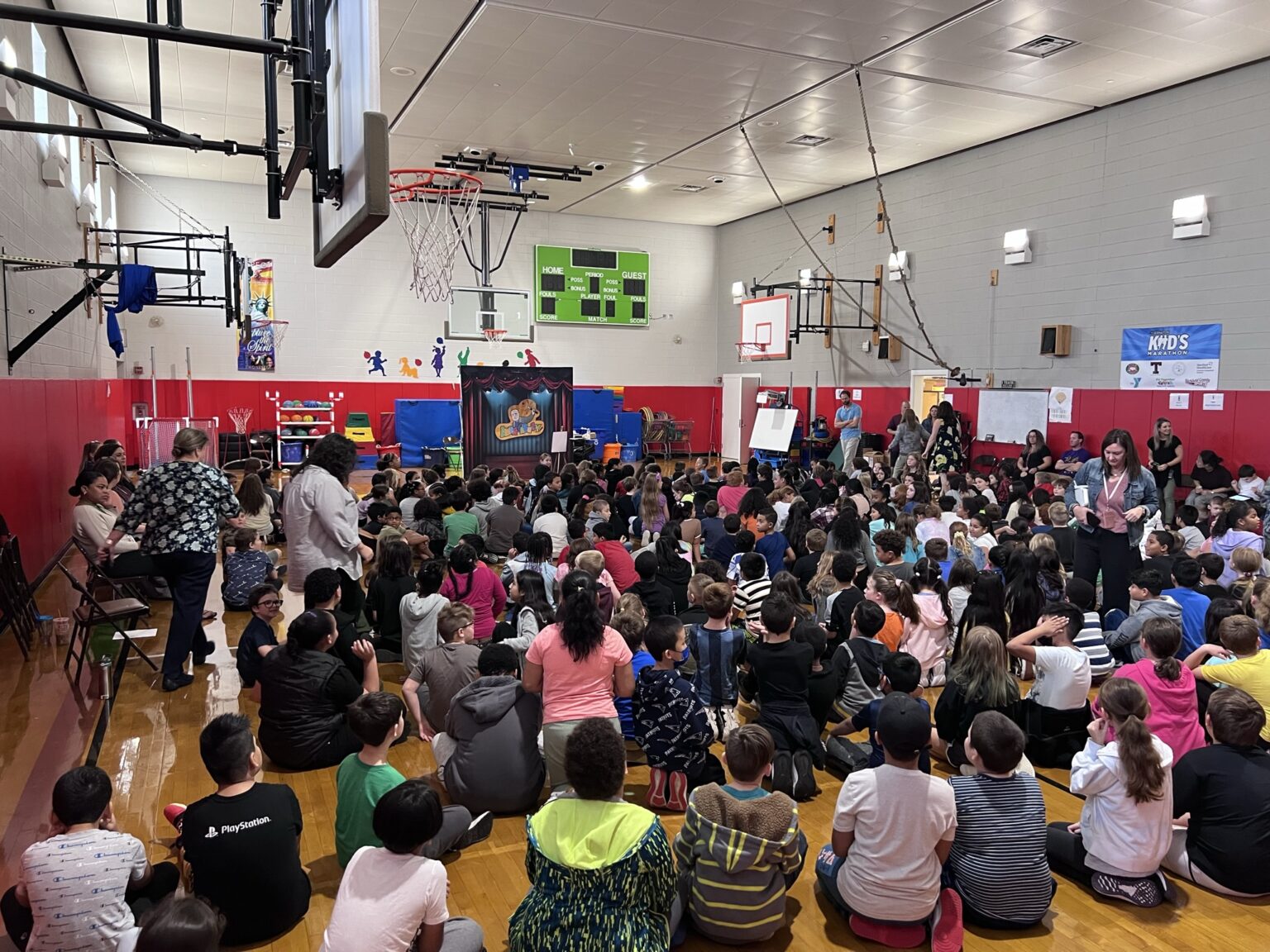 A group of people sitting in the middle of an auditorium.