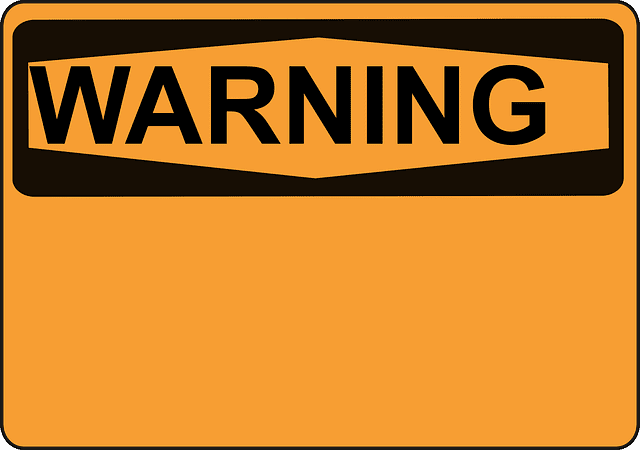 Warning sign in black with yellow background