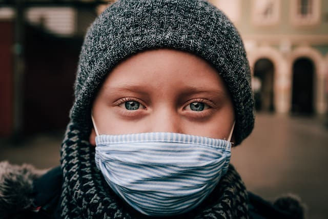 Child wearing a mask after attending a STEM school assembly