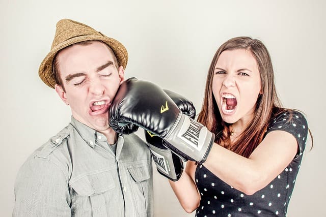 Woman punches man in the face.