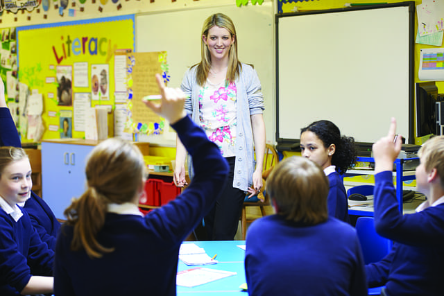 Teacher and students in a classroom.